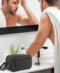 Man using Tactical Toiletry Bag For Men EDC Hygiene Kit With Molle Pouches in bathroom, featuring black military style design.