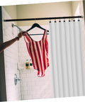 Bathroom with rustproof metal shower curtain rings 12 piece set for bathroom, smooth sliding on rod with red swimsuit hanging.