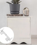 Zinc Alloy Folding Concealed Cabinet Hinges With Soft Close Buffer for tables in silver, shown on a white cabinet