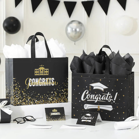 Two Pack 13 Inch Graduation Gift Bags With Tissue Paper And Cards, Reusable Nonwoven Gift Bags With Handles, Congrats Grad Gift Wrap Set For High School And College, Gift Bags For Ceremony, Gift Wrapping Supply displayed on a decorated table with balloons.