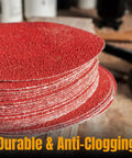 60 Grit 12 Inch PSA Sanding Discs 10 Pack Pro Grade Self Adhesive Sandpaper For Drywall Woodworking Paint Epoxy On Random Orbital DA Sanders Aluminum Oxide Discs stacked on table