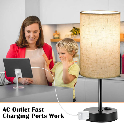 Set Of 2 Bedside Table Lamps For Bedroom And Living Room With 3 Way Dimmable Rocker Switch And Built In AC Outlet Flaxen Fabric Shade Black Base Nightstand And Desk Lamp For Cozy Home Decor shown charging a tablet on a kitchen counter.