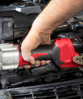 High-Torque M12 Cordless Rivet Gun Bare Tool Built to Rip Through Stainless Steel Rivets With Ease Featuring 3/16-Inch Pulling Power And 2000 Lbf Force Includes Mandrels, shown in use with a steady grip, fastening metal.