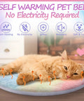Self Heating Cat Bed 2 Pack Machine Washable Pet Mat Reversible Thermal Warm Round Dog Crate Pad Tie Dye with an orange cat resting.