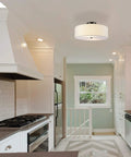 Two Light Flush Mount Ceiling Light In Dark Bronze With White Linen Drum Shade, Low Profile Design, shown in a kitchen setting