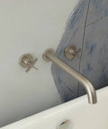 Wall Mount Tub Filler With Two Cross Handles, Extra Long 11 Inch Spout, High Flow Tub Faucet With Nickel Brushed Finish installed on wall