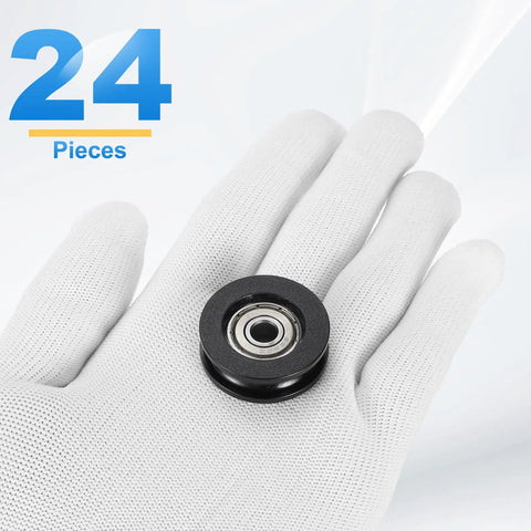 24 Pack Kickass Nylon U Groove Guide Bearings 6X11X31MM Black Plastic Linear Rollers displayed in a gloved hand.