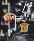 Barista using espresso machine with 4 Oz Espresso Cups 100 Pack Kraft Disposable Paper Cups For Home Office Or Party