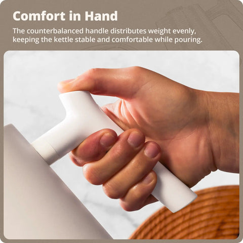 Hand holding handle of Electric Gooseneck Kettle With Precision Temperature Control 1200W Fast Boil 0.8L Stainless Steel BPA Free
