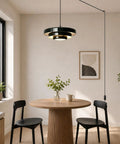 Black Swag Pendant Light Plug in hanging over a round dining table with layered metal shade and adjustable cord.