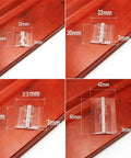 Two Pack Clear Plastic Folding Hinge For Doors And Cabinets with measurements on wooden surface