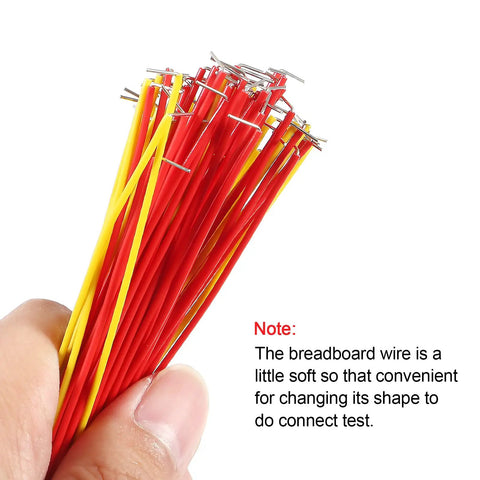 Close-up of a hand holding insulated red and yellow wires from 560 Piece Breadboard Jumper Wire Kit With 14 Lengths In Assorted Colors