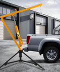 Heavy Duty Hydraulic Engine Hoist With Hitch Mount Truck Crane For 2 Inch Receiver fully adjustable boom in use beside truck.