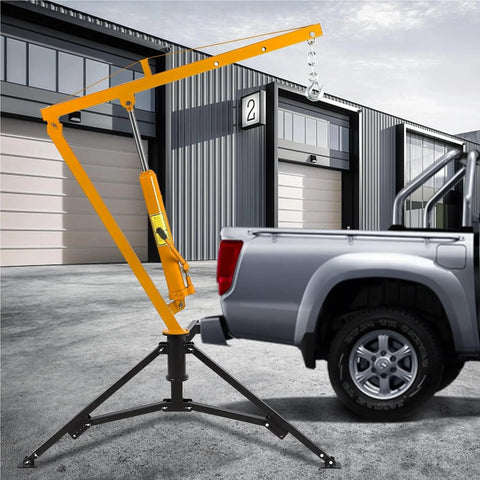 Heavy Duty Hydraulic Engine Hoist With Hitch Mount Truck Crane For 2 Inch Receiver fully adjustable boom in use beside truck.