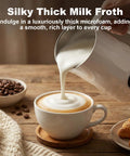 4 In 1 Milk Frother And Warmer pouring creamy microfoam into cup on wooden table, creating barista-quality latte at home