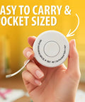 Hand holding a Retractable Tailor Tape Measure For Fabric And Sewing, 80 Inch And 2 Meter, Dual Sided Tape, pocket-sized view