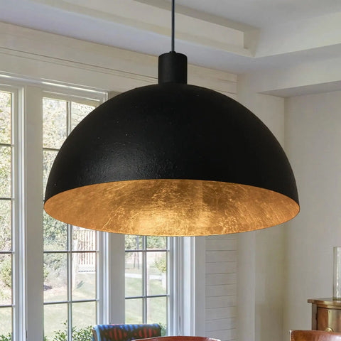 Black Dome Pendant Light With Dope Gold Leaf Interior, 20 Inch Industrial Chandelier hanging in a dining room.