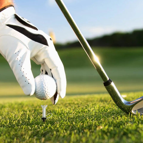 Golfer placing ball on High-Performance 5 Pack Golf Tees With 360 Degree Rotating Base Low Friction Crown Patented Bounce Tech
