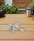 Badass Heavy Duty Stainless Steel Pin Hinges Built Tough For Barn Doors And Shed Gates With Detachable Male Female Mechanism Super Easy Wall Mount Gate Hardware Includes Outdoor Screws Pack Of Two on wooden table.