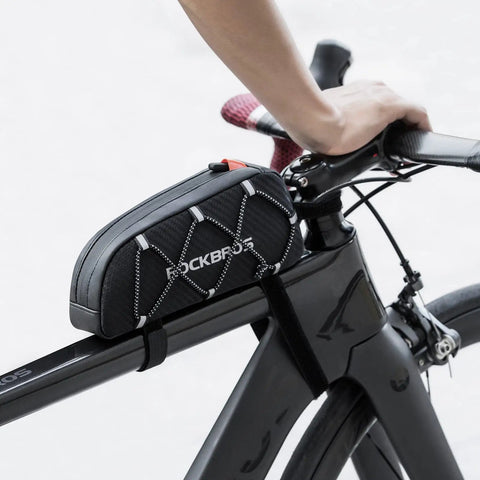 Ride Ready Front Frame Bag For Bikes With Large Capacity Main Compartment, installed on top tube of black bike, hand on handlebars