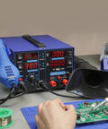 All In One Soldering Station With Hot Air Rework, Power Supply And USB 3A Output on workbench with operator using soldering iron