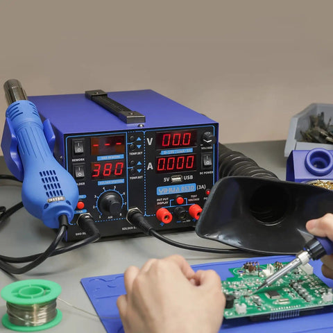 All In One Soldering Station With Hot Air Rework, Power Supply And USB 3A Output on workbench with operator using soldering iron