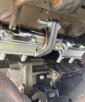 Exhaust Flange Repair Piping Kit 2.5 Inch ID To 2.5 Inch OD With Gasket And Bolt installed on car exhaust system.