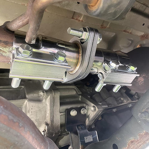 Exhaust Flange Repair Piping Kit 2.5 Inch ID To 2.5 Inch OD With Gasket And Bolt installed on car exhaust system.