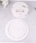 Bottom view of the MiniKEYA Electric Rotating Display Stand USB Powered Turntable with sturdy white ABS base and internal mechanism.