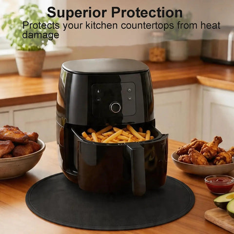 Air fryer on 20 Inch Round Tabletop Fire Pit Mat Pro Grade Heat Resistant Silicone Countertop Protector on kitchen counter.