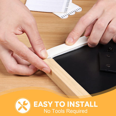 Heavy Duty Picture Hanging Strips Solid As A Rock For Wall Frames And Decor, Zero Wall Damage, Super Durable Adhesive Holds Firm Without Any Nails, No Sweat Installation, Bright White being applied to a frame.