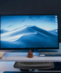 Undermount Keyboard Tray With Ergonomic Tilt And Clip Mount under a screen, showcasing a sleek black design and desk setup.
