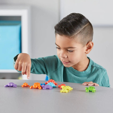 Child playing with Tactile Turtles Math Activity Set for Toddlers and Preschoolers, Kid Friendly Color Sorting Counters for Counting.