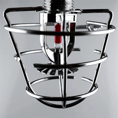 Tough As Nails Automatic Fire Sprinkler Head Machined From Solid Brass Secured By Reinforced Steel Guard Cage, visible red glass element.