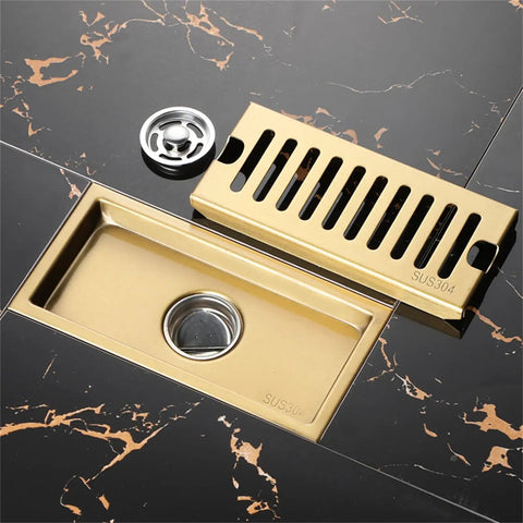 Heavy Duty Gold Linear Shower Drain With Brick Pattern Grate And Built In Hair Catcher For Bathrooms That Keeps Things Fresh With Quick Drain Performance and Smooth Operation Zero Drama Setup Brings Home The Best on black marble floor.