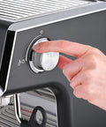 User adjusting the control knob on a Fully Automatic Espresso Machine With Badass Burr Grinder And Hella Smooth Pulls.