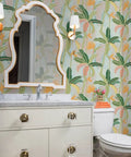 Tropical Botanical Vinyl Wallpaper Featuring Subtle Leather Texture Built Different Heavy Duty Commercial Grade Finish Custom Printed, view of bathroom with green and yellow leaf pattern.
