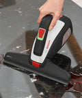 Bosch GlassVAC battery window vacuum cleaner, handheld black and white unit, front view with red power switch on glass.