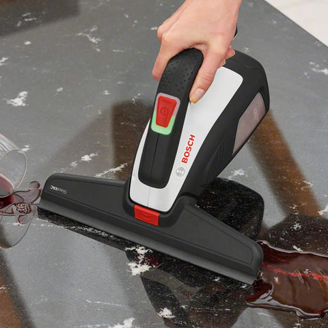 Bosch GlassVAC battery window vacuum cleaner, handheld black and white unit, front view with red power switch on glass.