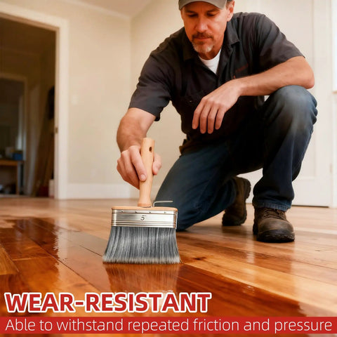 Man using wide brush on wooden floor with Deck Stain Brush Set 3 Pack With 4 Inch 5 Inch 6 Inch Wide Brush For Stains Paints And Limewash Includes Extension Pole Perfect For Decks Fences Walls And Furniture On Wood Or Masonry.