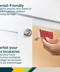 Hand installing Adhesive Cabinet Latch Set 4 Piece For Childproofing White Peel And Stick Easy Install No Tools Required