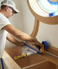 Person using Advanced Masking Film For Indoor Outdoor Painting, 8 Rolls, 72 Inches By 90 Feet, Static Cling Keeps Film In Place