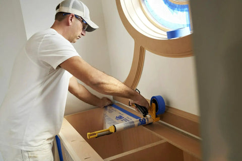 Person using Advanced Masking Film For Indoor Outdoor Painting, 8 Rolls, 72 Inches By 90 Feet, Static Cling Keeps Film In Place
