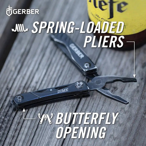 Mini 12-In-1 EDC Multitool With Needle Nose Pliers shown in black finish, open on wooden surface, with bottle nearby.