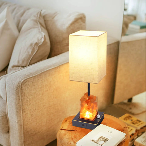 Touch Table Lamp With USB Ports And Himalayan Salt Nightstand Light on a wooden table beside a sofa in a living room setting.