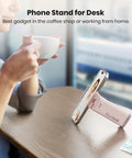 Airplane Phone Holder Mount for Travel Must Haves, light pink phone stand on a table, hands-free device angle demonstration.