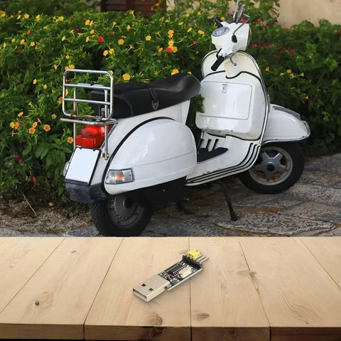 USB To TTL Programmer Cable For STC Microcontrollers on wooden table, garden scooter in background