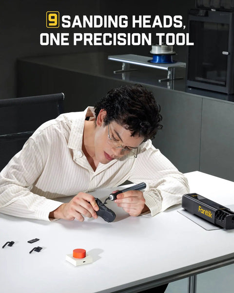 User operating Badass Brushless Electric Detail Sander For Sweet 3D Print Finishing And Quick Model Sanding With Jam Free Reciprocating Design And Built Tough For Maker Folks, with sanding heads and tools on a table.