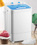 Compact Portable Washing Machine With 7.5 Liter Basin For Quick Laundry And Sneaker Scrubs Nifty Desktop Washer displayed next to clothes and shoes.