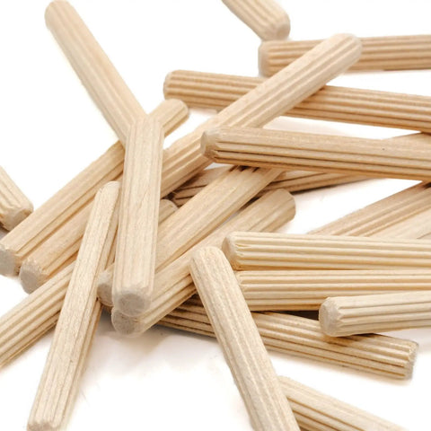 Heavy Duty Wooden Dowel Pins Six By Fifty Millimeter Straight Shot Replacement For Flat Pack Furniture And Wobbly Shelves Solid Core Joint Reinforcement Makes Quick Repairs A Total Breeze. Beige hardwood dowel pins scattered on a white background.